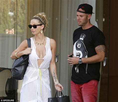 sarah harding gives cheeky glimpse of her bikini when her cover up flies open as she leaves la