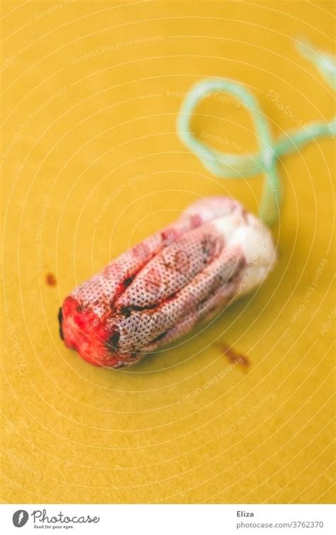 Bloody Tampon On Yellow Background Menstruation A Royalty Free Stock Photo From Photocase