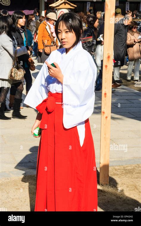 Japanese Shinto Shrine At New Year A Shrine Maiden Miko Standing In