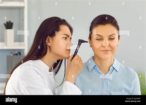 Ent Doctor Uses Otoscope To Examine Young Womans Ear During Medical