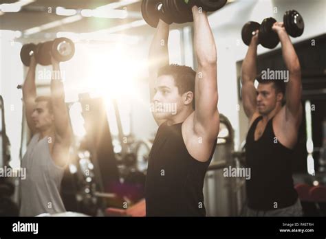 Group Of Men With Dumbbells In Gym Stock Photo Alamy