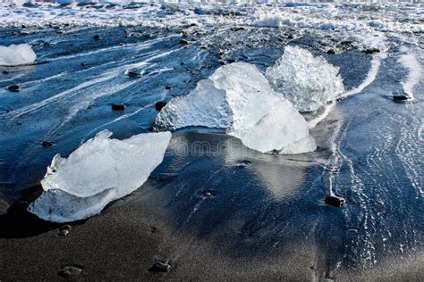 Large Pieces Of Iceberg On Black Sand Beach In Iceland Stock Photo