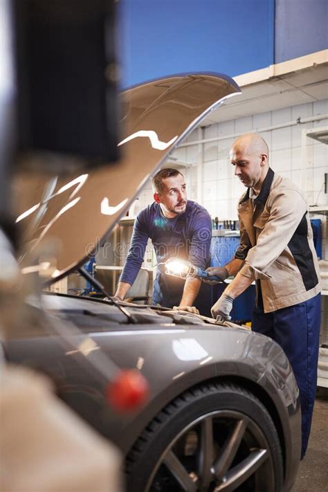 Workers Inspecting Car In Auto Shop Stock Photo Image Of Males