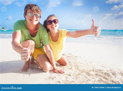 Closeup Of Happy Young Caucasian Couple In Sunglasses Smiling On Beach