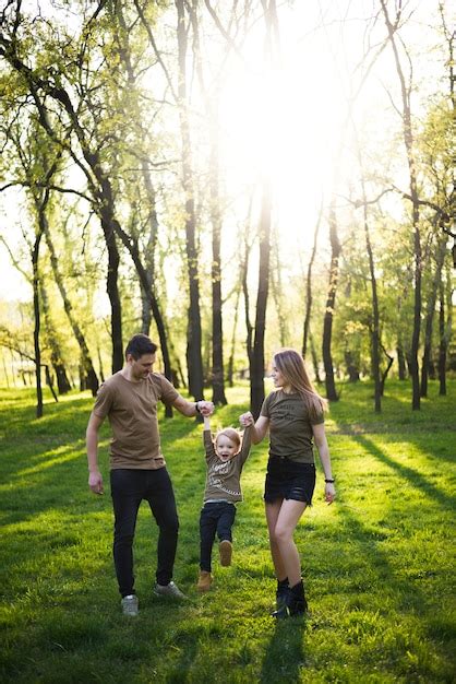 Happy Parents With Child In Nature Photo Free Download