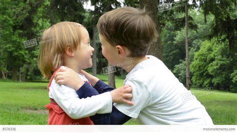 Children Siblings Boy And Girl Give A Kiss In Park Stock Video