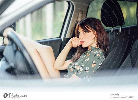 Woman Resting In A Car Pulling Her Feet Out The Window A Royalty Free