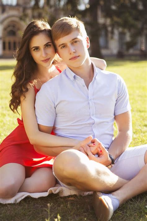 Beautiful Brunette Couple In Love Hugging On A Date In The Park Stock