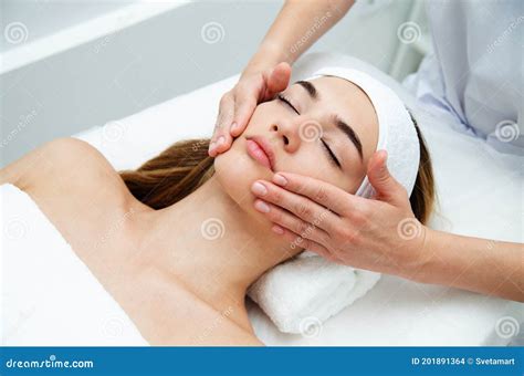 Beautician Massaging Woman`s Face Attractive Girl Having Facial Treatment And Massage Stock