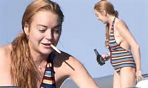 Lindsay Lohan Shows Pregnant Stomach In Bathing Suit As She Smokes A