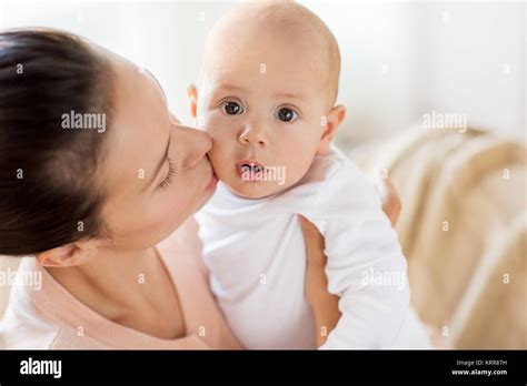 Happy Mother Kissing Little Baby Boy At Home Stock Photo Alamy