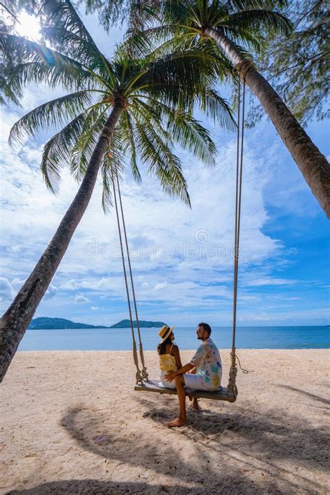 Couple On The Beach In Phuket Relaxing On Beach Chair Tropical Beach