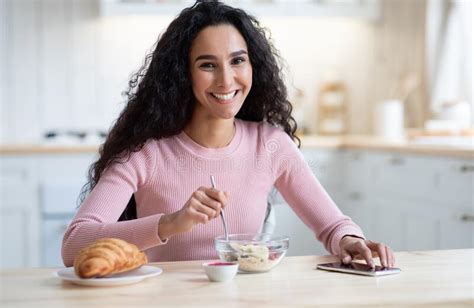 Domestic Morning Happy Woman Eating Healthy Breakfast And Using