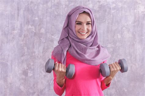 Hijab Sporty Asian Woman Looking At A Smart Wristband To Set The Time