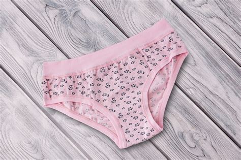 premium photo pink cotton panties on the wooden surface