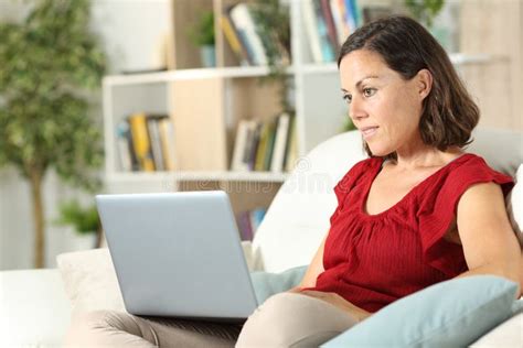 serious adult woman looks at laptop sitting at home stock image image of homeowner apartment