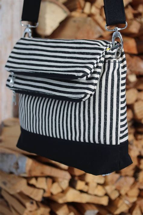 The Double Flip Shoulder Bag Features 2 Full Length Zipper Pockets That