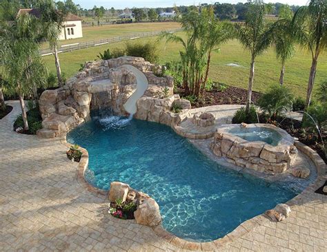 A backyard swimming pool integrated with a hot tub. pool beach entry grotto jacuzzi slide - Google Search ...