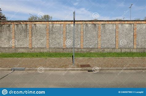 Concrete Wall With Strips Of Bricks A Line Of Grass A Porphyry