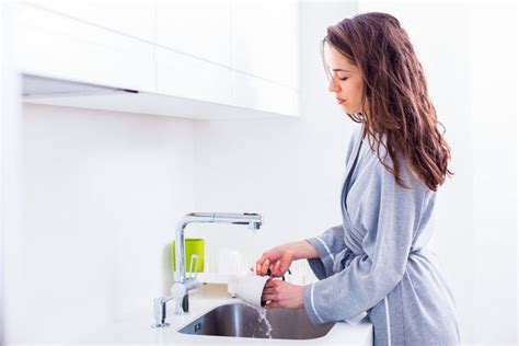 Young Woman Washing Dishes While Standing Id 116031759