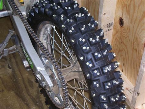 A Close Up Of A Motorcycle Tire With Studs On It