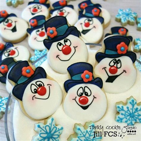 Some Frosted Cookies With Snowmen And Hats On Top Of Each Other In