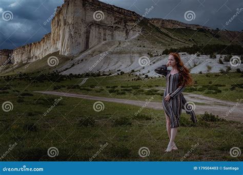 Fashion Young Ginger Woman Standing Outdoor On Breathtaking View Of Dramatic Storm Sky Stock