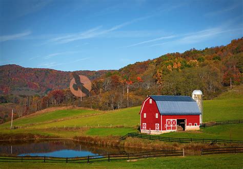 Bright Red Barn With Pond Surrounded By Fall Colors In West Virginia