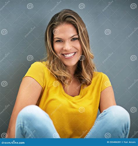 Wearing Confidence Like An Accessory A Young Woman Posing Against A
