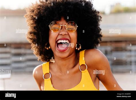 Beautiful Young Happy African Woman With Afro Curly Hairstyle Strolling In The City Cheerful