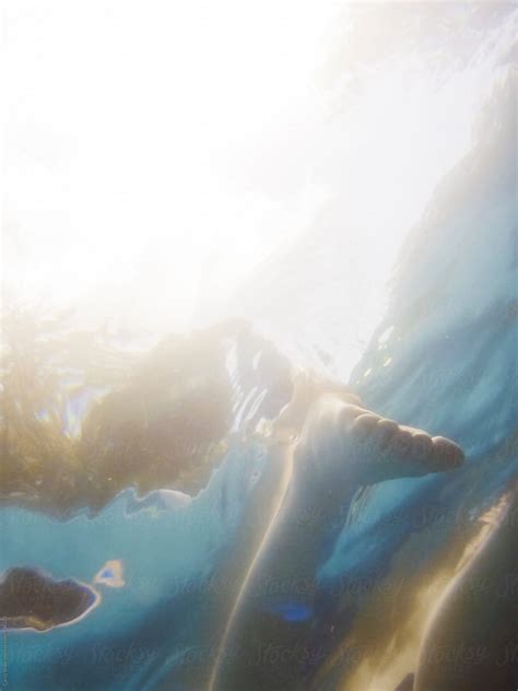 Underwater View Of Woman Floating In Pool By Stocksy Contributor Carey Shaw Stocksy
