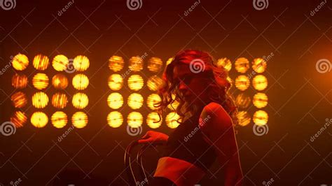 girl practicing erotic strip movements sitting chair on nightclub stage close up stock image