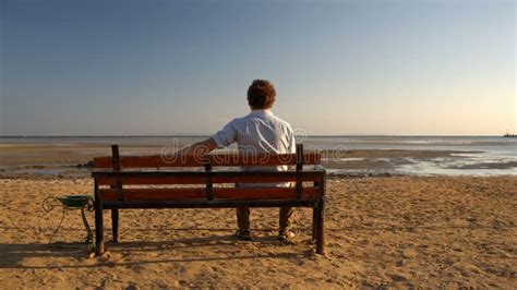Young Man Sitting On A Beach Alone And Lonely Stock Footage Video Of