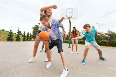 Group Of Happy Teenagers Playing Basketball Stock Photo Image Of