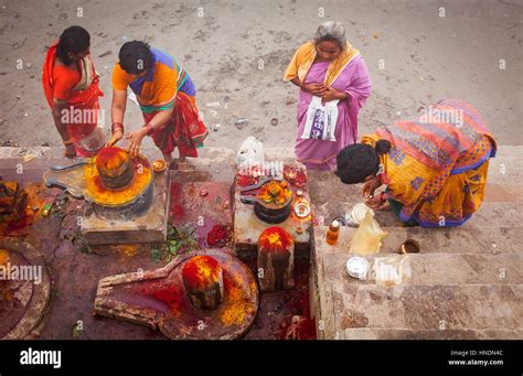 women pilgrims making a ritual offering and praying ghats of ganges river varanasi uttar