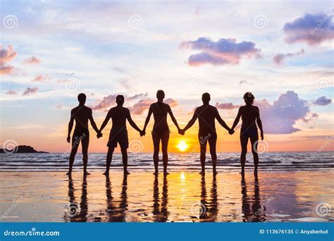 Group Holding Hands Sunset