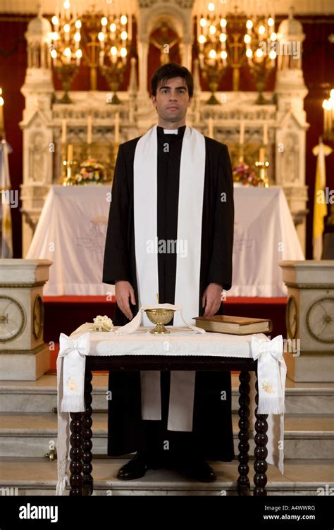 Robed Priest Standing At The Altar Of A Church Stock Photo Alamy