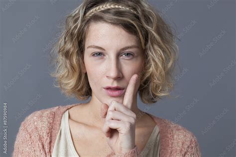 threatening 20s blonde girl showing her index finger for signal of danger risk or behaving with