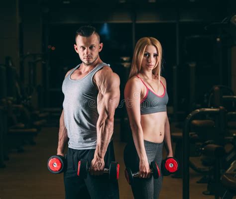 Beautiful Young Sporty Couple Showing Muscle And Workout In Gym