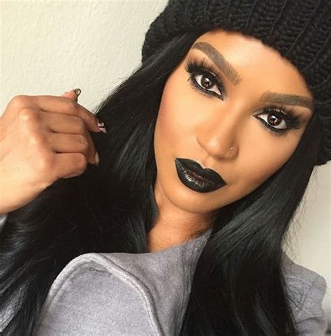 Black Woman Putting On Lipstick
