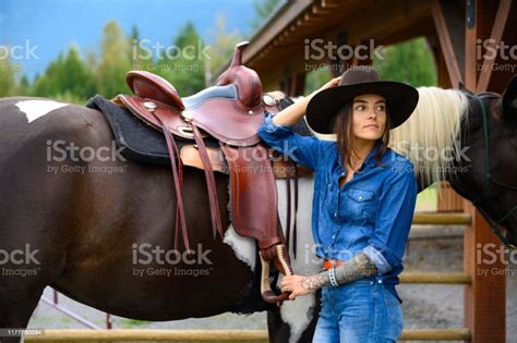 Female Rancher Working With Her Horse Stock Photo Download Image Now