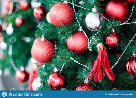 Closeup Of Red Bauble Hanging From A Decorated Christmas Tree H Stock