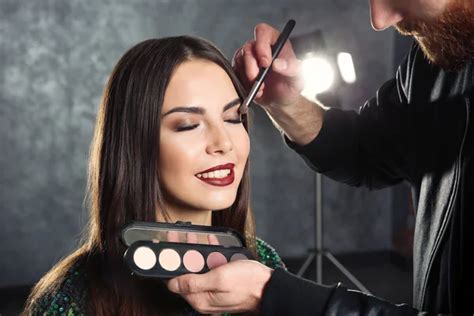 Professional Makeup Artist Working With Beautiful Young Woman Stock