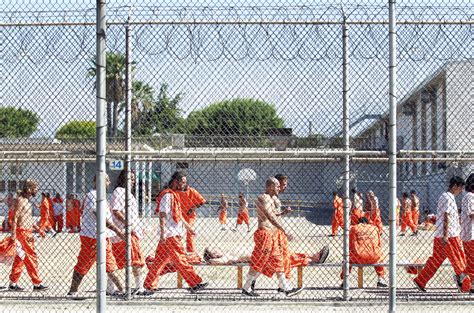 Inmates Walk Around An Exercise Yard At The California Institution