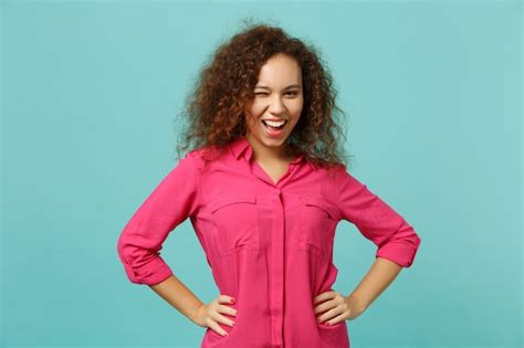 Free Photo Portrait Of Cheerful Blinking African Girl In Casual Clothes Standing With Arms