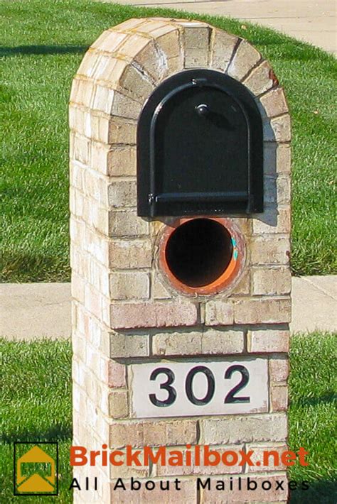 This construction also includes a mailbox plaque with gold frame, sign and number. cast stone number block