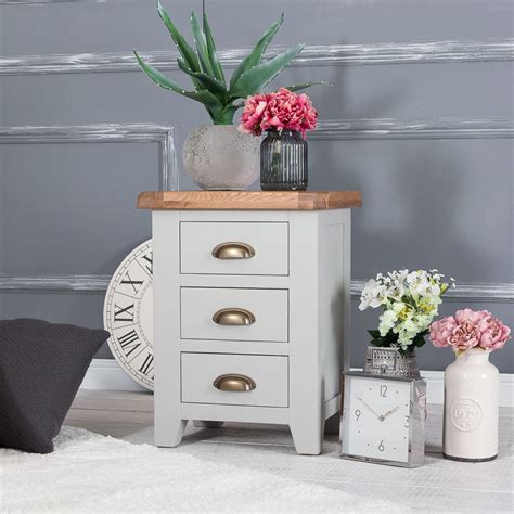 A simple oak bedside table made in a compact and sleek design works well with current spaces. Hampshire Grey Painted Oak Large 3 Drawer Bedside Table in ...