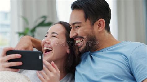 funny couple selfie streaming video online and relax together in house influencer on social