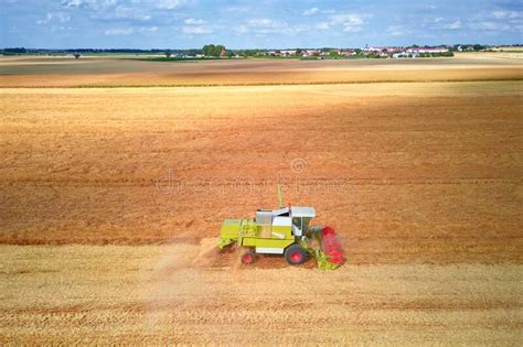 Aerial View Of Working Harvesting Combine In Wheat Field Harvest