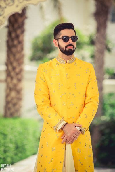 a larger than life wedding with impressive decor and outfits and a groom in a manarkali